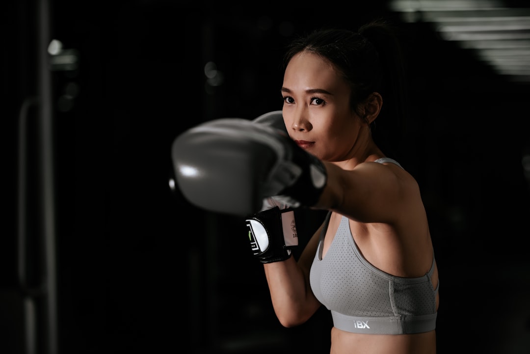Woman training in boxing gloves, keeping a strong flat wrist to prevent wrist pain